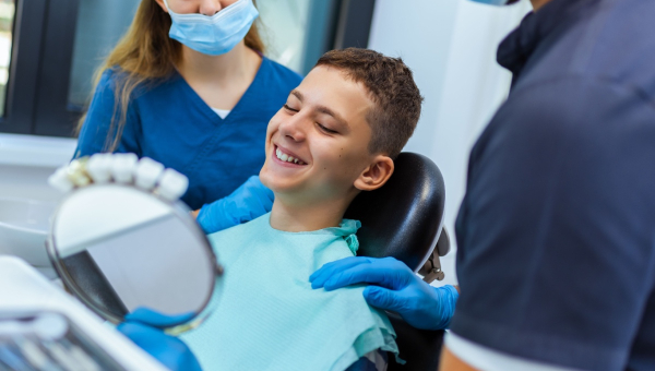 A dentist showing a happy patient our dental recordkeeping app